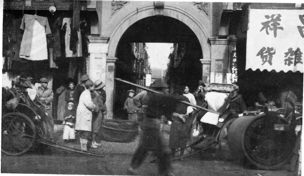 A lilong entrance, laundry hung across the lane
