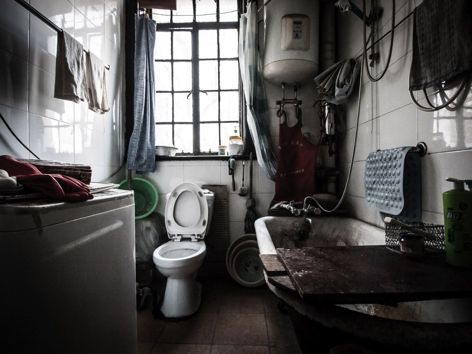A shared washroom: one lavatory, and a water boiler for each household on the floor.
